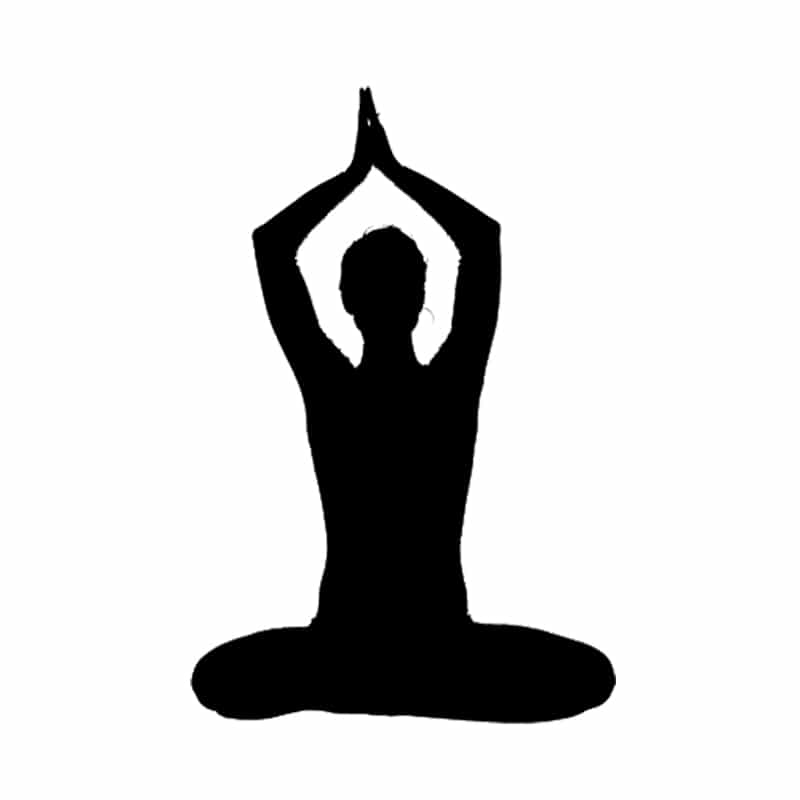 silhouette of person seated in yoga pose